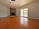 Spacious living room with hardwood floors, fireplace, and sliding glass doors leading to the pool at 206 Westmoor Bnd, Orlando, FL 32835
