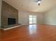 Inviting living room with hardwood floors, a stone fireplace, and sliding glass doors to the pool area at 206 Westmoor Bnd, Orlando, FL 32835