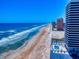Beautiful aerial view of the beach with ocean and condos and a community pool in Daytona Beach, Florida at 2101 N Atlantic Ave # 10, Daytona Beach, FL 32118