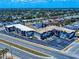 An aerial view shows this multi-unit apartment building and surrounding neighborhood with palms and tropical landscaping at 2101 N Atlantic Ave # 10, Daytona Beach, FL 32118