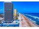 Beautiful aerial view of the beach with ocean and condos and a community pool in Daytona Beach, Florida at 2101 N Atlantic Ave # 10, Daytona Beach, FL 32118