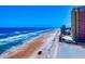 Beautiful aerial view of the beach with ocean and condos and a community pool in Daytona Beach, Florida at 2101 N Atlantic Ave # 10, Daytona Beach, FL 32118