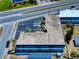 Real estate photo showcasing rooftop, designated parking area, limited landscaping, and nearby road at 2101 N Atlantic Ave # 10, Daytona Beach, FL 32118