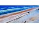 Aerial view of the beach with blue waves, brown sand, and a row of hotels and condos in Daytona Beach, Florida at 2101 N Atlantic Ave # 10, Daytona Beach, FL 32118