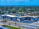 An aerial view shows this multi-unit apartment building and surrounding neighborhood with palms and tropical landscaping at 2101 N Atlantic Ave # 10, Daytona Beach, FL 32118