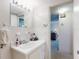 Bathroom with a vanity, mirror, and doorway to another room at 2101 N Atlantic Ave # 10, Daytona Beach, FL 32118