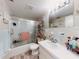 Bathroom with a vanity, shower and tub, and tiled walls at 2101 N Atlantic Ave # 10, Daytona Beach, FL 32118