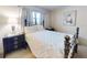 Bedroom with a patterned comforter on a black iron bed frame, side tables, and artwork at 2101 N Atlantic Ave # 10, Daytona Beach, FL 32118