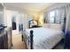 Comfortable bedroom features a metal frame bed, neutral carpet, and a sunny window at 2101 N Atlantic Ave # 10, Daytona Beach, FL 32118