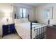 Bedroom with a patterned comforter on a black iron bed frame, side tables, and artwork at 2101 N Atlantic Ave # 10, Daytona Beach, FL 32118