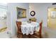 Cozy dining area with wooden table, chairs, and floral tablecloth, adjacent to the kitchen at 2101 N Atlantic Ave # 10, Daytona Beach, FL 32118