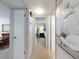 Hallway with carpeted floors, neutral walls, doorways, and artwork at 2101 N Atlantic Ave # 10, Daytona Beach, FL 32118
