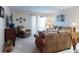 Well-lit living room offering cozy furniture, a television, and access to outdoor space at 2101 N Atlantic Ave # 10, Daytona Beach, FL 32118