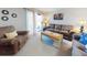 Cozy living room with a sofa, accent chair, and sliding doors filling the space with light at 2101 N Atlantic Ave # 10, Daytona Beach, FL 32118