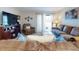 Inviting living room with a large TV, comfortable seating, and natural light from a sliding door at 2101 N Atlantic Ave # 10, Daytona Beach, FL 32118