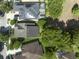 Aerial shot of a home with solar panels, a screened-in pool, and a well-maintained backyard at 220 Asterbrooke Dr, Deland, FL 32724
