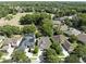 A high angle view of a neighborhood with tree lined streets, well manicured lawns, and screened-in patios at 220 Asterbrooke Dr, Deland, FL 32724