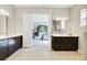 Bathroom with double vanities and open doorway to bedroom at 220 Asterbrooke Dr, Deland, FL 32724
