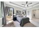 Comfortable bedroom featuring neutral decor, chair, ceiling fan, and ensuite bathroom access at 220 Asterbrooke Dr, Deland, FL 32724