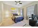 Cozy bedroom featuring neutral tones, ceiling fan, bedside table, and natural light at 220 Asterbrooke Dr, Deland, FL 32724