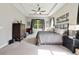 Spacious main bedroom suite with tray ceiling, large window and neutral decor at 220 Asterbrooke Dr, Deland, FL 32724