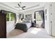 Bright main bedroom suite with tray ceiling, large window and neutral decor at 220 Asterbrooke Dr, Deland, FL 32724