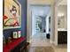 Open hallway with neutral paint and tile, decorated with eye-catching art and views to the backyard at 220 Asterbrooke Dr, Deland, FL 32724
