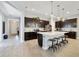 Bright kitchen featuring a large island, pendant lighting, stainless appliances, and dark cabinets at 220 Asterbrooke Dr, Deland, FL 32724