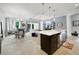 Bright, open-concept kitchen with stainless steel appliances, an island and views to the Gathering and dining areas at 220 Asterbrooke Dr, Deland, FL 32724
