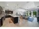Spacious open living area with a kitchen island, dining table, and comfortable lounge with view to the backyard at 220 Asterbrooke Dr, Deland, FL 32724