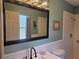 Bathroom featuring a white vanity, commode and a tiled walk-in shower reflected in a large mirror at 2204 Poinsettia Dr, Deland, FL 32724