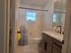 Clean bathroom features a shower/tub combo, modern vanity and a bright window at 2204 Poinsettia Dr, Deland, FL 32724