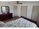 Cozy bedroom features a ceiling fan, closet, and natural light at 2204 Poinsettia Dr, Deland, FL 32724