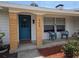Charming front porch featuring a stylish blue door and welcoming decor at 2204 Poinsettia Dr, Deland, FL 32724