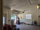 Spacious garage with an open door, white block walls, and convenient overhead storage at 2204 Poinsettia Dr, Deland, FL 32724