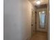 Bright hallway with tile floors, mirrored wall, and closet at 2204 Poinsettia Dr, Deland, FL 32724