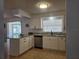 Bright kitchen with white cabinets, stainless steel appliances, granite counters, and tile floors at 2204 Poinsettia Dr, Deland, FL 32724
