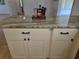 Close up of kitchen island with white cabinets and an elegant granite countertop at 2204 Poinsettia Dr, Deland, FL 32724