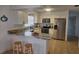 Modern kitchen with white cabinetry, granite countertops, and stainless steel appliances at 2204 Poinsettia Dr, Deland, FL 32724
