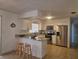 Updated kitchen featuring white cabinets, granite counters, stainless steel appliances, and breakfast bar at 2204 Poinsettia Dr, Deland, FL 32724