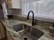 Kitchen sink with granite countertops, stylish faucet, and a bright window view at 2204 Poinsettia Dr, Deland, FL 32724