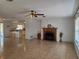 Open living area with tile flooring, fireplace, and ceiling fan, flowing into the kitchen at 2204 Poinsettia Dr, Deland, FL 32724