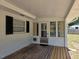 Enclosed porch with wood deck, multiple windows, and lots of light at 2204 Poinsettia Dr, Deland, FL 32724