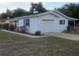 Well-maintained home exterior features a garage, manicured landscaping, and a freshly painted exterior at 2204 Poinsettia Dr, Deland, FL 32724