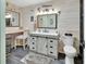 Charming bathroom with whitewashed wood paneling, vanity with drawers, and nautical decor at 2329 River Ridge Rd # 4, Deland, FL 32720