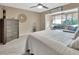 Comfortable bedroom featuring a gray quilted bedspread and adjacent sunroom at 2329 River Ridge Rd # 4, Deland, FL 32720