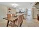 Open-concept dining room with modern table, seamlessly connecting to the kitchen and living area at 2329 River Ridge Rd # 4, Deland, FL 32720