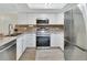 Modern kitchen features stainless steel appliances, white cabinetry, and stylish backsplash at 2329 River Ridge Rd # 4, Deland, FL 32720