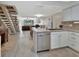 Open-concept kitchen featuring white cabinets, stainless steel appliances and island with breakfast bar at 2329 River Ridge Rd # 4, Deland, FL 32720