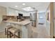 Bright kitchen features white cabinets, stainless steel appliances, breakfast bar and stylish backsplash at 2329 River Ridge Rd # 4, Deland, FL 32720